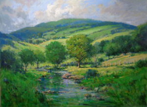 blue stream flows from green mountains with white clouds in light blue sky